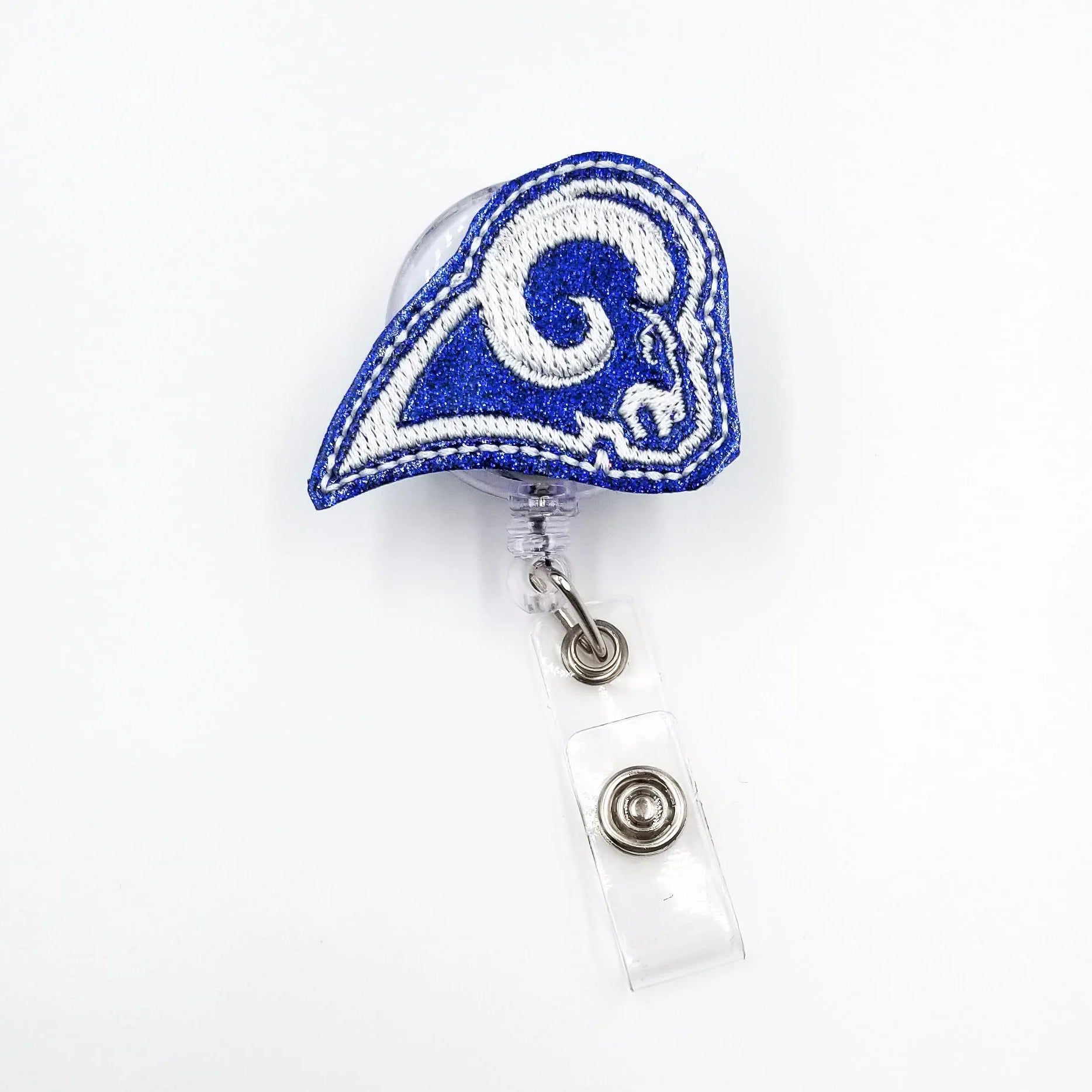 Blue glittery ram helmet embroidered badge reel with clear retractable holder on white background