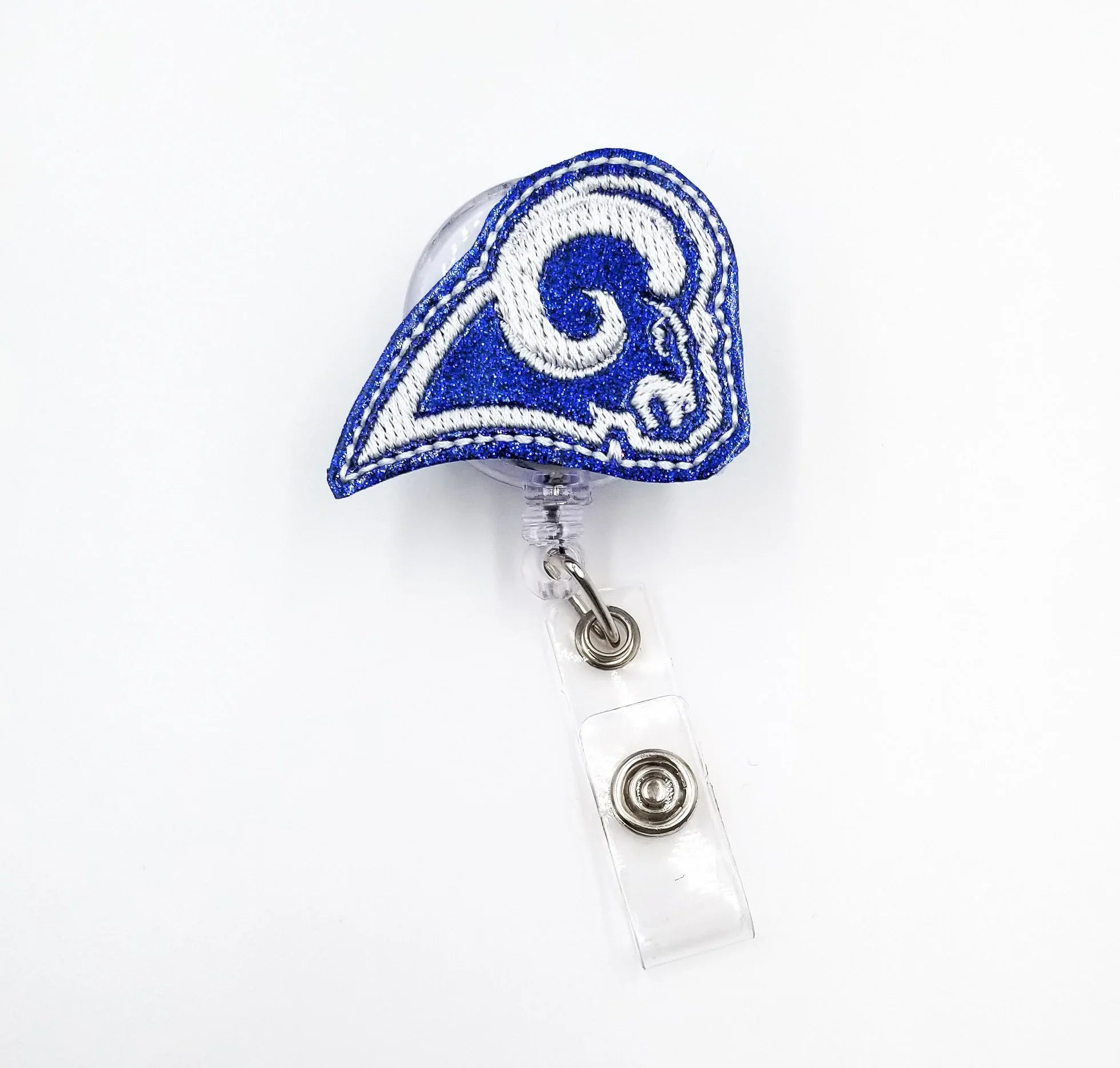 Blue glittery ram helmet embroidered badge reel with clear retractable holder on white background