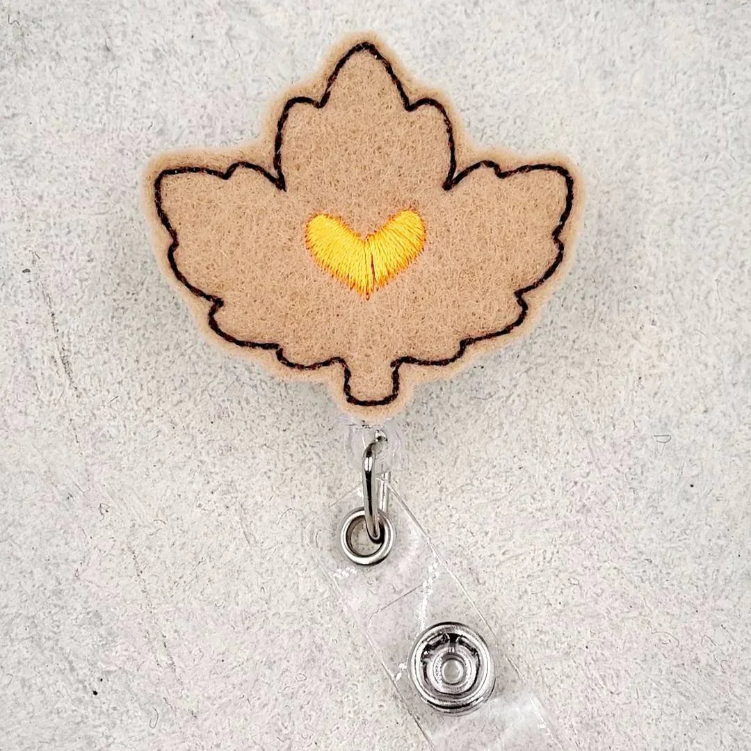 Felt maple leaf badge reel with yellow heart embroidery, cute accessory for nurses